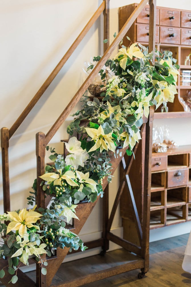 fresh flower pointsettia eucalyptus holiday party stairs garland