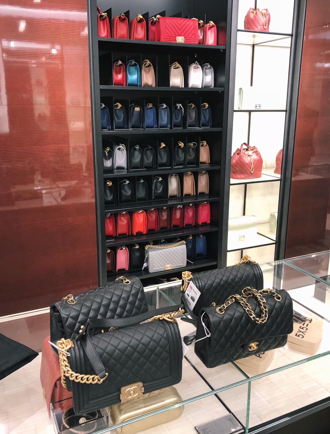 Boston style blogger, Extra Petite is comparing different sizes and leathers of the Saint Laurent Wallet on Chain and the Chanel Boy Bag!